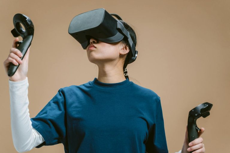 Woman engaging with virtual reality using a VR headset and controllers.